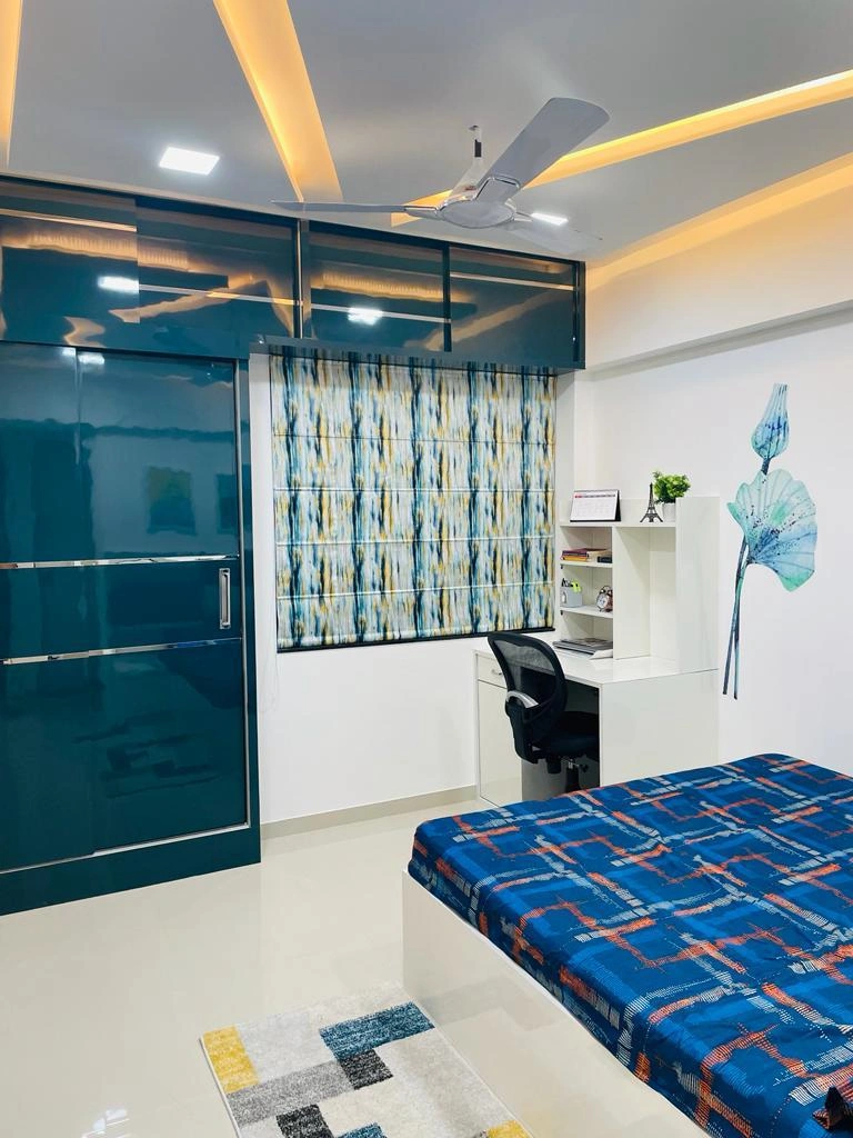 Bedroom with teal wardrobe and study desk